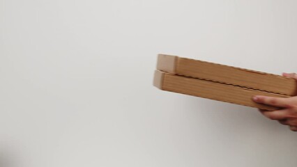 Square cardboard boxes on white background. Preparing take away meals. Online contactless food shopping. Food delivery service. Courier taking order, delivering to customer. 