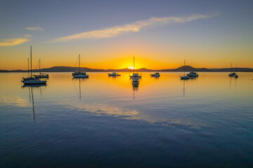 Aerial sunrise waterscape with boats