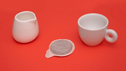 Espresso cup and pod on red background