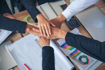 Partners hands together teamwork group of business people meeting in firm company office. Diversity...