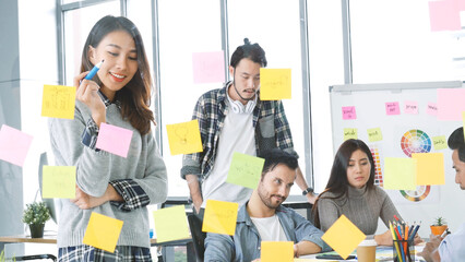 Creative design woman present talking use sticky notes post, present ideas. Diversity multi ethnic...