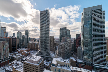 Downtown Toronto Younge and Wellesley st in the winter time snow on buildings blue skies 