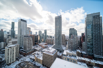 Naklejka na ściany i meble Downtown Toronto Younge and Wellesley st in the winter time snow on buildings blue skies 