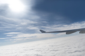 Fototapeta na wymiar The airplane flew over the clouds