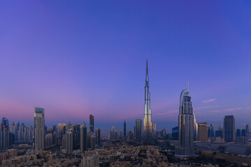 Urban skyline and cityscape at sunrise in Dubai.