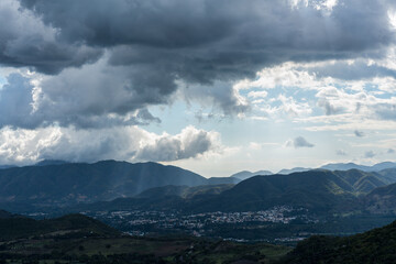 Dramatic image after a rainstorm in the Caribbean mountains of the Dominican Republic, with a small town in the valley.