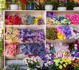 Beautiful multicolored artificial flowers background. flowers decor