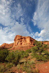 Mountains made of red rocks near Sedona Arizona with a blue sky and perfect clouds as a vertical image