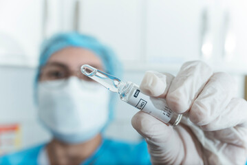 A nurse presents a 2 ml Tramadol HCL ampoule. Opioid pain medication. Medical supplies at the hospital or ER.