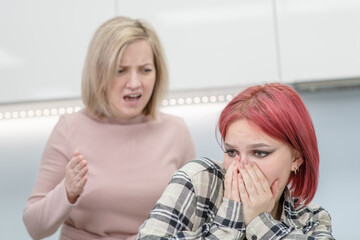 Obraz na płótnie Canvas Family conflict. Angry mother screams at crying teen daughter