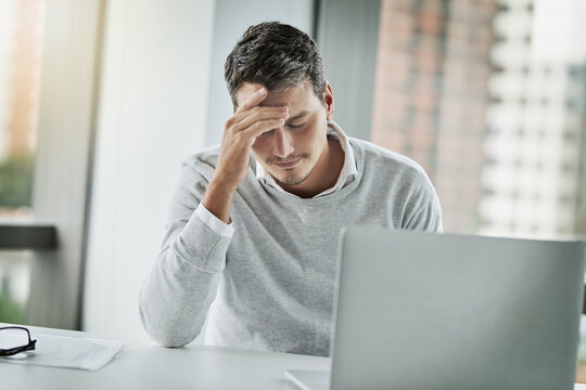 How did I manage to mess this up.... Shot of a young businessman looking stressed out while working in an office.