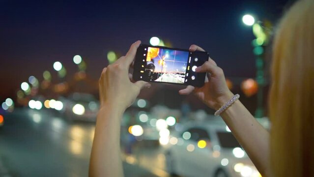 Young Woman Using Smartphone in the City, Taking Pictures. 