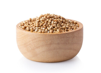 coriander seeds in wood bowl isolated on white