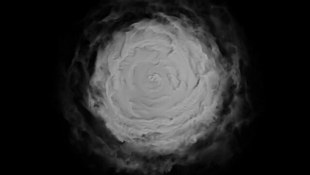 A disc of gray dense smoke swirls counterclockwise against a black background. View of the cyclone from above.
