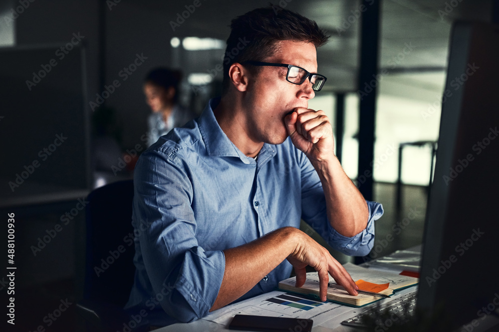 Canvas Prints the late shift can get exhausting. cropped shot of a young attractive businessman working late in th