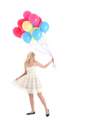 
Full length portrait of blonde girl wearing party dress, holding bunch of colourful balloons. Isolated on white studio background