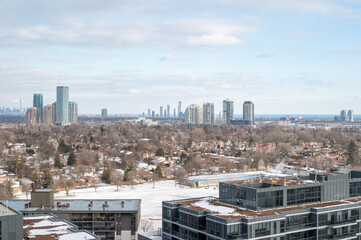 views of downtown Toronto from mimco with snow and trees blue skies lake view and CN tower  in view 