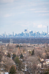 views of downtown Toronto from mimco with snow and trees blue skies lake view and CN tower  in view 