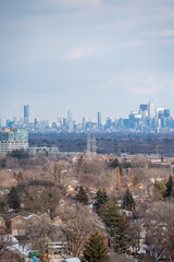 views of downtown Toronto from mimco with snow and trees blue skies lake view and CN tower  in view 
