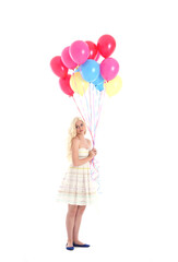 
Full length portrait of blonde girl wearing party dress, holding bunch of colourful balloons. Isolated on white studio background