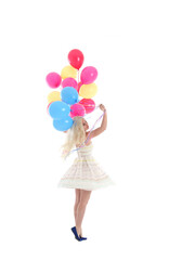 
Full length portrait of blonde girl wearing party dress, holding bunch of colourful balloons. Isolated on white studio background