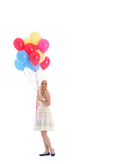 
Full length portrait of blonde girl wearing party dress, holding bunch of colourful balloons. Isolated on white studio background