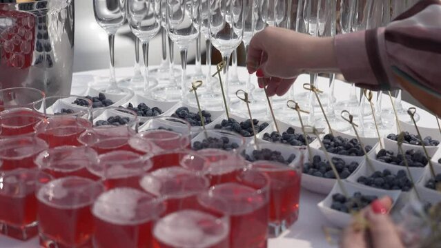 buffet in nature but round table with white tablecloth. Berries, juice and champagne glasses