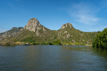 Fototapeta na wymiar along with river side of mangrove forest with green moutain and clear blue sky