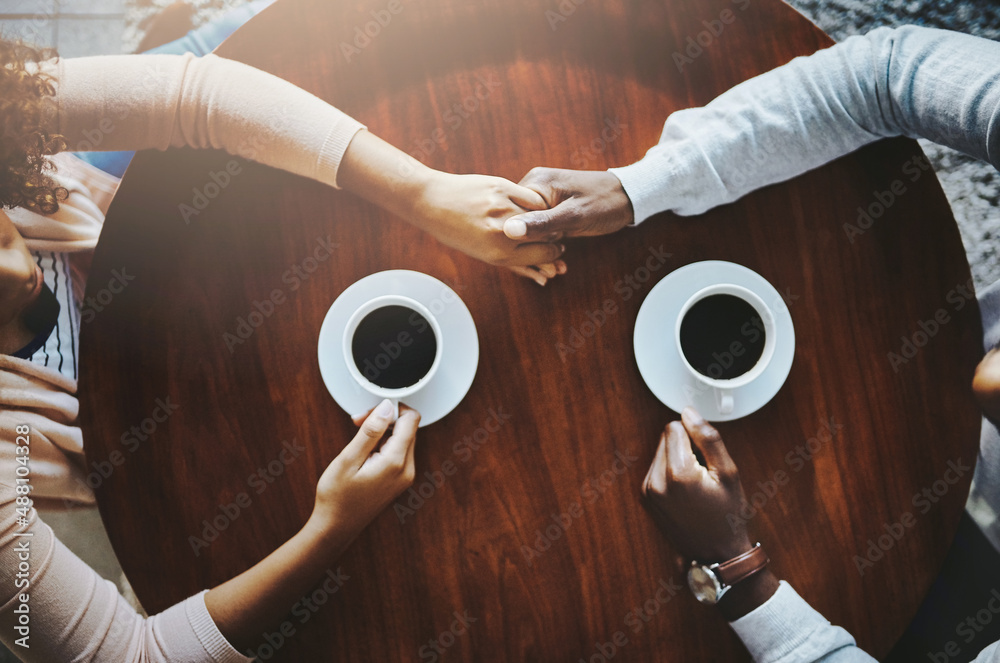 Poster coffee has a magical way of bringing people together. high angle shot of an affectionate couple on a