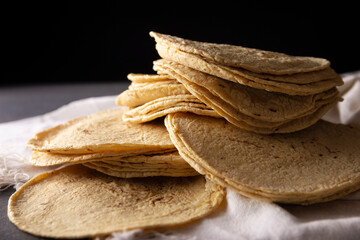 Corn Tortillas. Food made with nixtamalized corn, a staple food in several American countries, an...