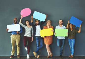 Let us help you get your word out. Studio shot of a diverse group of people holding up speech bubbles against a gray background. - obrazy, fototapety, plakaty