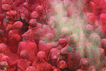 People throw colours to each other during the Holi celebration in Nandgaon, Uttar Pradesh, India....