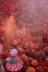 People throw colours to each other during the Holi celebration in Nandgaon, Uttar Pradesh, India....