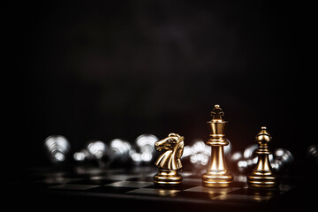 Close-up king chess standing with teamwork on chess board concept of team player or business team...