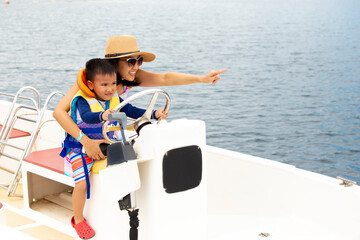 mother and her son pretending to drive the boat