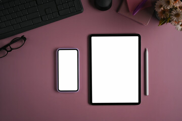 Flat lat smart phone, digital tablet and stylus pen on purple background.