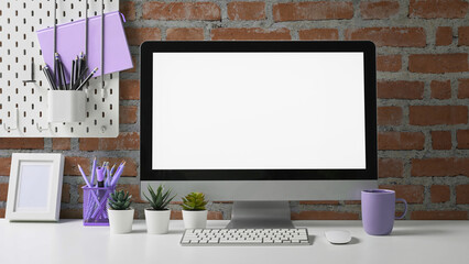 Stylish workspace with mock up computer and office supplies on white table. Blank screen for graphic display montage.