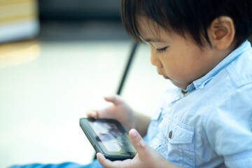 cute little boy playing gadget