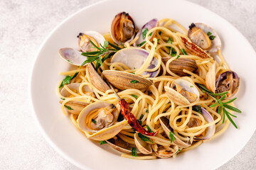 Seafood pasta with clams Spaghetti alle Vongole on a light background