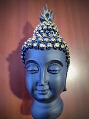 Buddha in a meditation pose, under protection of the king of nag - Mukalinda. Figure isolated on a black background.