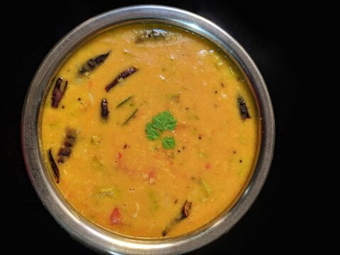 Andra style tomato pappu dal with toor dal and Moong dal. Indian cuisine dish. Tasty south Indian dish. Indian popular food Dal Tadka Curry served with roti flatbread close-up on the table,india.