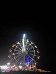 A giant wheel of fair in India,the Largest Ferris Wheel in the World, silhouette giant swing on twilight time of the day - can use to montage or portcard. Visible noise, india