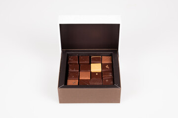 Assortment brown milk black cacao square artisanal chocolate candies in little gift box