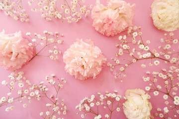 feminine wedding desktop with baby's breath Gypsophila flowers and pink beautiful flowers on pink background. Empty space. Floral frame, web banner. Top view. Picture for blog or social media