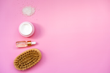 skin care concept, scrub and skin massage, top view on pink background