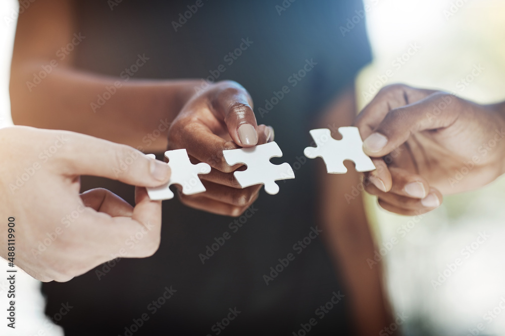 Poster There is no solution greater than teamwork. Cropped shot of a work group connecting pieces of a puzzle.
