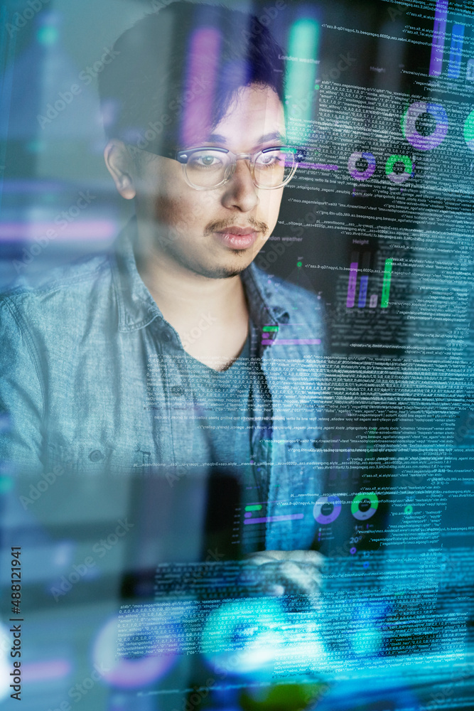 Poster Writing code is what he does. Cropped shot of a young computer programmer looking through data.