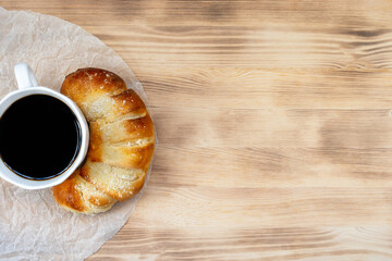 fresh pastries and coffee on wooden background, top view, breakfast concept