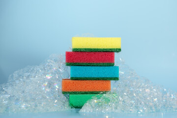 multi-colored sponges for washing dishes in foam, the concept of cleanliness