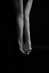 Refined and elegant hands of a dancer, dancing with body parts, black and white portrait of the performer's hands on a dark background